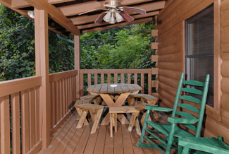 Tennessee Vacation Cabin Rental that features a quiet outdoor seating area and picnic table